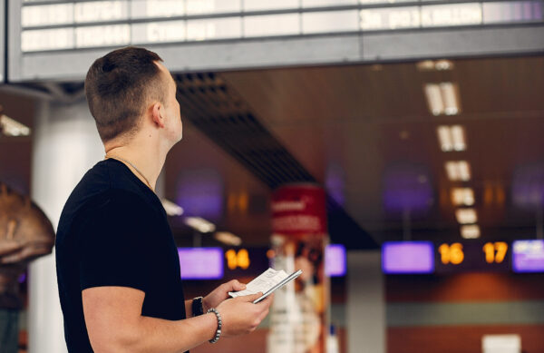 Man in a airport. Handsome man in a black t-shirt